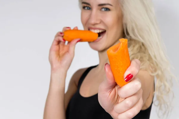 depositphotos_146737177-stock-photo-young-woman-eating-a-carrot